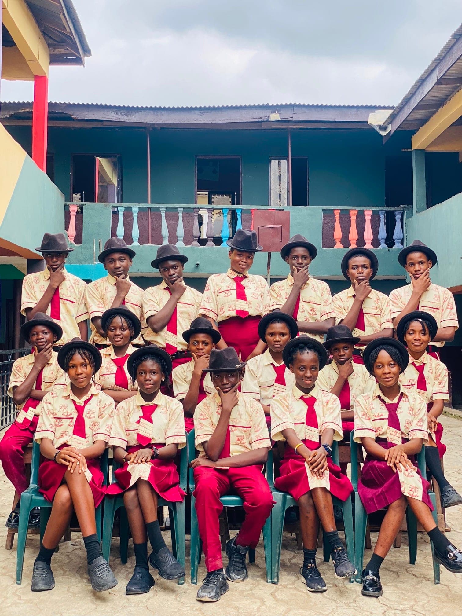 Senior students posing confidently for a class photograph in the school courtyard